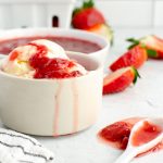 Strawberry Sauce over ice cream in a dish