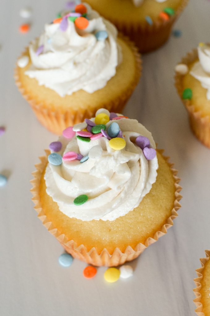 Overhead of frosted yellow cupcakes