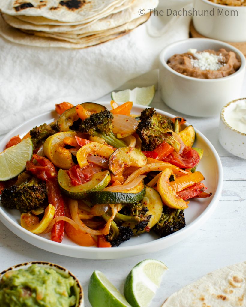 Fajita veggies on a plate with sides nearby