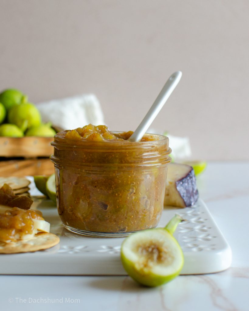 Fresh green fig jam next to a basket of figs