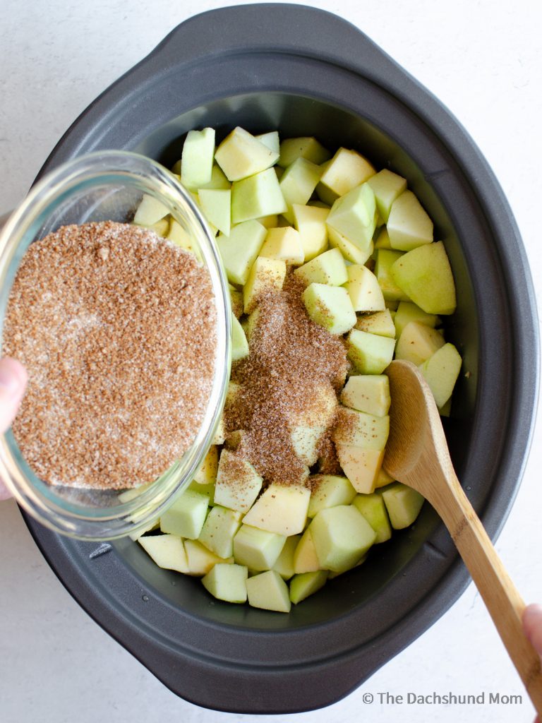 stirring sugars with apples for apple butter