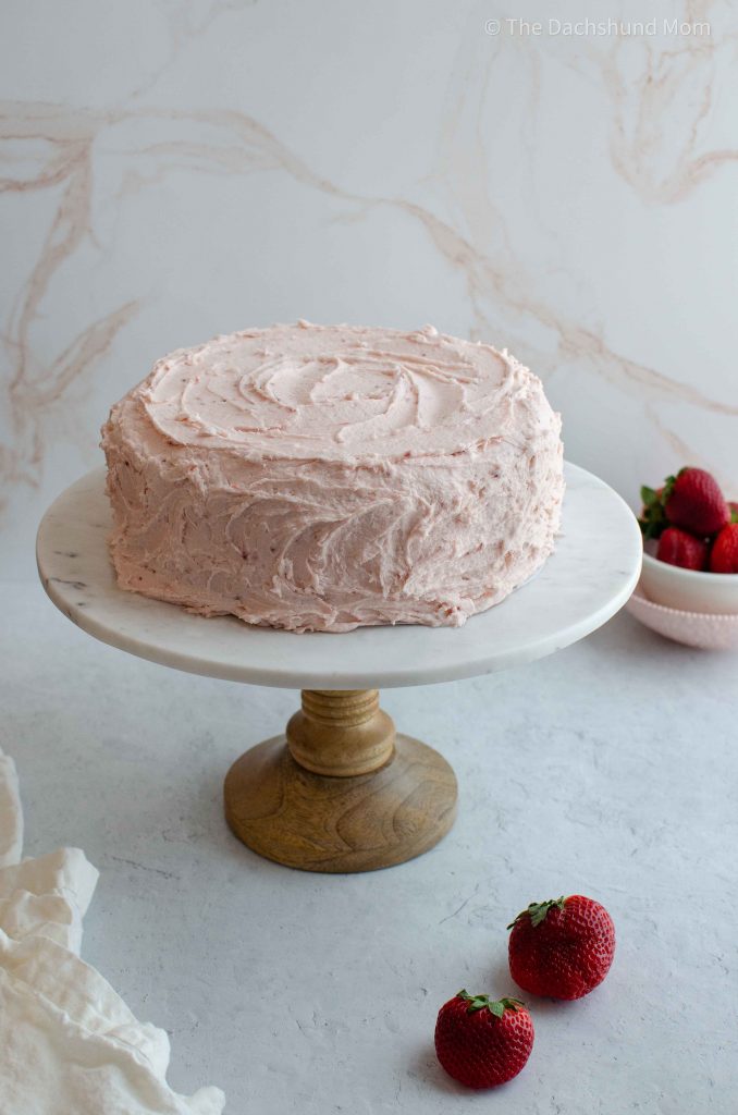 Strawberry layer cake with strawberry buttercream frosting.