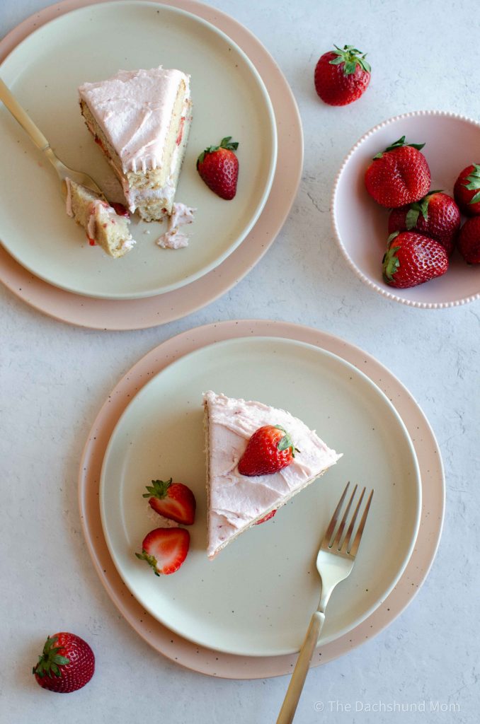 Strawberry layer cake slices on plates.
