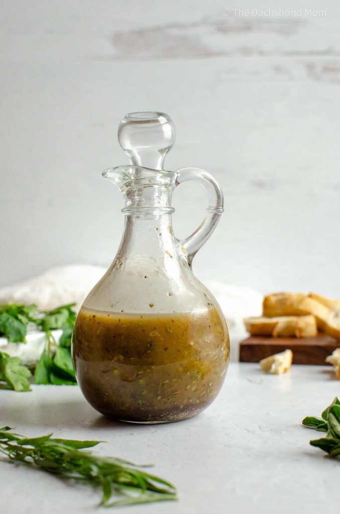 Fresh herb vinaigrette and bread dipping oil in a glass bottle.